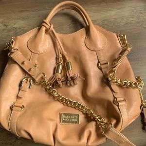 Large leather satchel handbag. Gold detail. Includes shoulder strap.